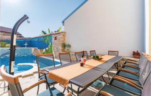 a patio with a table and chairs and a pool at Holiday Home Vodnjan 44 With Outdoor Swimmingpool in Vodnjan +34 photos