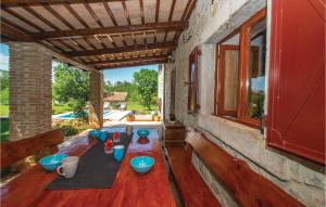 a patio with blue bowls on a wooden floor at Holiday Home Gondolici Croatia in Labin