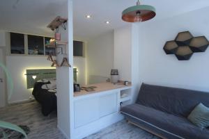 a living room with a couch and a table at Appartement 90 m2 in Vic-sur-Seille