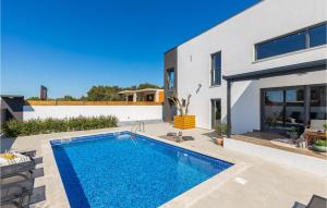 a swimming pool in the backyard of a house at Villa Arcus in Pakoštane +37 photos