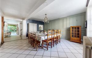 a large dining room with a table and chairs at Lovely Home In Villeneuve-Sur-Yonne in Villeneuve-sur-Yonne +17 photos