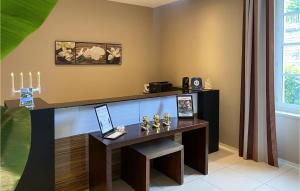 a office with a desk with a laptop on it at Nice Apartment In Saint-Affrique in Saint-Affrique +17 photos