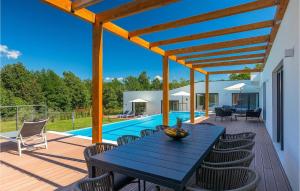 a patio with a blue table and chairs and a pool at Villa Istria Green in Kršan