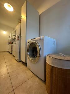 a laundry room with a washing machine and refrigerators at Casa Armonía Paz y confort ideal para familias buscando naturaleza in Bella Vista +48 photos