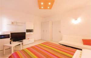 a white room with a bed and a flat screen tv at Apartment Fazana 09 in Fažana +10 photos
