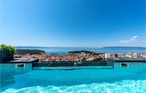 a large swimming pool with a view of the ocean at Villa Rhapsody 2 Aurelia 2 in Makarska