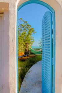 a blue gate leading to a playground with a hammock at Mirante do Edom in Maceió