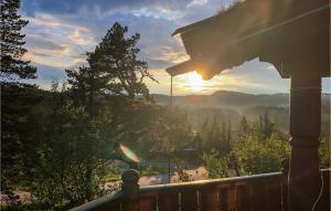 a view of the sun setting from a deck at Lovely Home In Veggli With Kitchen in Veggli