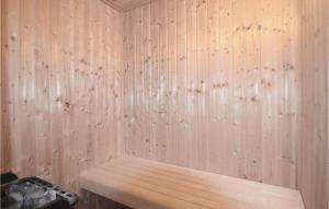 a wooden wall of a sauna with a wooden bench at Four-Bedroom Holiday Home In Nysted in Nysted