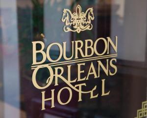 
a sign on a window in front of a store at Bourbon Orleans Hotel in New Orleans
