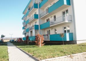 a building with blue balconies on the side of it at Apartament Rubin in Sibiu