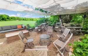 a group of chairs and a table and a barrel at Lovely Home In Saint-Félix-De-L'héras in Saint-Félix-de-lʼHéras +34 photos