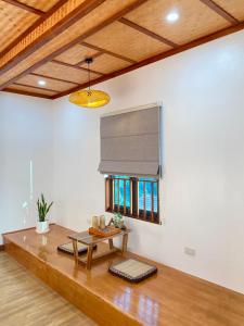 a living room with a table and a window at Ohayo Tam Coc Homestay in Ninh Binh