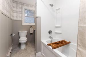 a white bathroom with a toilet and a sink at 4Bdrm Muskoka Retreat, Fire Table, Games, Netflix in Port Carling +114 photos