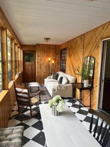 a living room with a couch and a table at 4Bdrm Muskoka Retreat, Fire Table, Games, Netflix in Port Carling