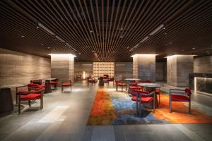 a lobby with tables and chairs and a fireplace at Apec Boutique Hotel Phú Yên in Tuy Hoa
