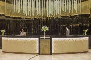 two people sitting at tables in a lobby at 1br - 5 min from Burj Khalifa and Mall - Best view in Dubai +14 photos