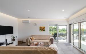 a living room with a couch and a table at Nice Home In Krnica With Jacuzzi in Krnica