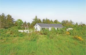 a white house in the middle of a field at Holiday Home Sivsangervej Vestervig X in Vestervig