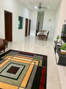a living room with a rug on the floor at Impiana Inn Seri Manjung in Seri Manjung