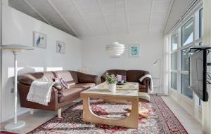 a living room with two couches and a coffee table at Three-Bedroom Holiday Home In Sydals in Østerby