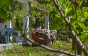 a table and chairs in the yard of a house at Two-Bedroom Holiday Home In Dolenja Vas in Dolenja Vas +14 photos