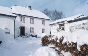 a house covered in snow next to a building at Haus Marx in Dürler