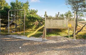 a playground with a slide and a swing at Holiday Home Bakkedraget Blåvand X in Blåvand +10 photos