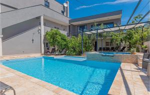 a swimming pool in the backyard of a house at 1 Bedroom Lovely Apartment In Brodarica in Brodarica +29 photos