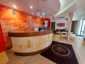 a lobby with a bar in the middle of a room at Hotel Slamený Dom & SPA in Košice