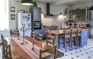 a kitchen with a wooden table and a refrigerator at Amazing Home In Saint-Christoly-Médoc in Saint-Christoly-Médoc +22 photos