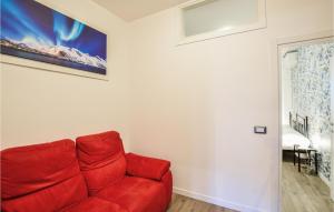 a red couch sitting in a living room at Stunning Apartment In Cervia With Wifi in Cervia