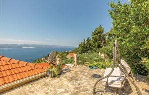 a patio with chairs and a view of the water at Holiday Home Mimice 21 With Outdoor Swimmingpool in Mimice