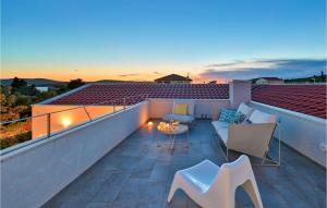 a balcony with a table and chairs on a roof at Villa Vela Muline in Zadar