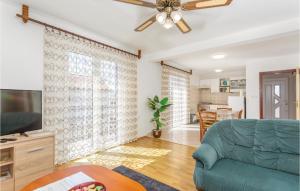 a living room with a couch and a flat screen tv at Nice Apartment In Krk With Wifi in Brzac