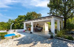 a pergola with a patio and a pool at Cozy Home In Malinska With Wifi in Malinska