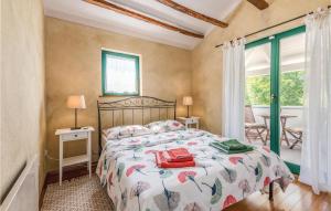 a bedroom with a large bed and a window at Cozy Home In Malinska With Wifi in Malinska