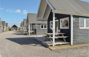 a house with a picnic table in front of it at Hytte 17 in Thyborøn