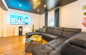 a living room with a couch and a tv at Beach Front Home In Vir in Vir