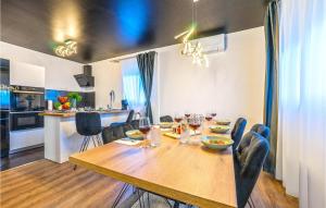 a dining room with a wooden table and chairs at Beach Front Home In Vir in Vir