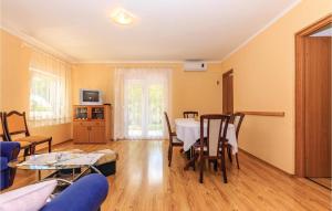 a dining room with a table and chairs at 3 Bedroom Gorgeous Apartment In Grizane in Grižane +15 photos