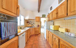 a kitchen with wooden cabinets and white appliances at Lovely Home In Aspiran in Aspiran