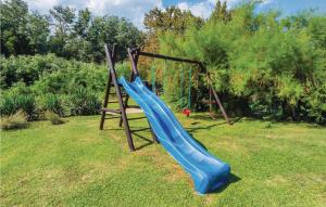 a playground with a blue slide in a yard at Apartment Nedescina Brnjci in Santalezi