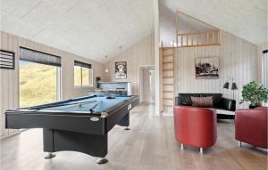 a living room with a pool table in it at Awesome Home In Hvide Sande With Sauna in Havrvig