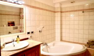 a bathroom with a white tub and a sink at Family and Friends , Familienapartment Playa de San Juan in Guía de Isora +38 photos