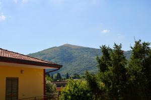 a house with a mountain in the background at B&B Gentile in Castel Morrone