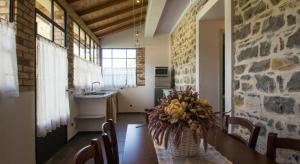 a kitchen with a table with a vase of flowers on it at Agriturismo Ada Musso ss in Diano Borello