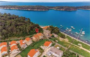 an aerial view of a house next to a body of water at 1 Bedroom Cozy Apartment In Palit in Palit