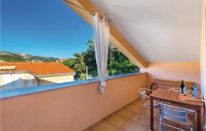 a balcony with a table and a window at 1 Bedroom Cozy Apartment In Palit in Palit +21 photos