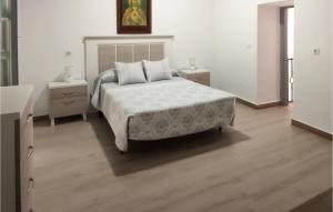 a bedroom with a large bed and two night stands at Beautiful Home In Nerja With Wifi in Nerja